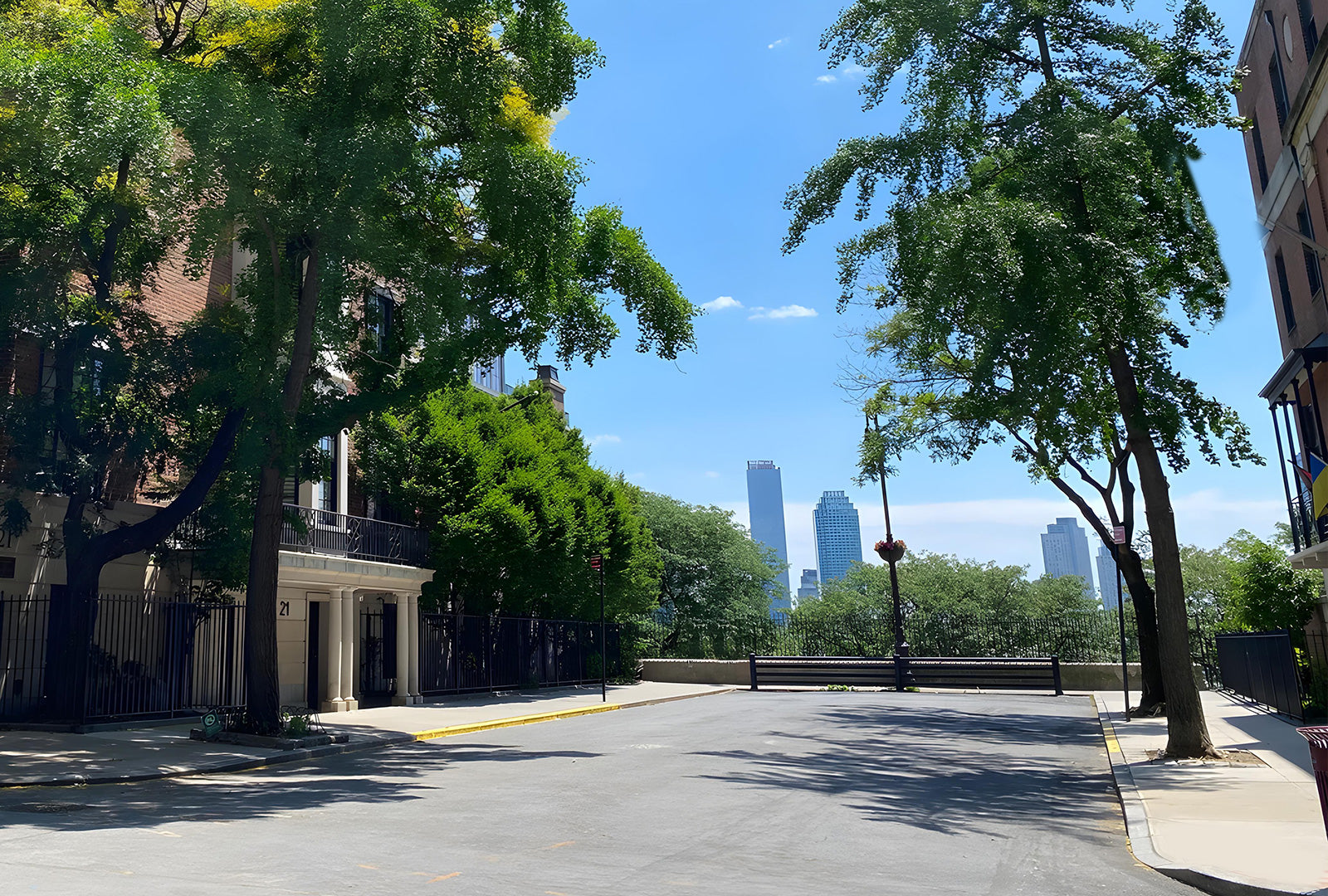 Street view with trees, buildings, and a clear sky