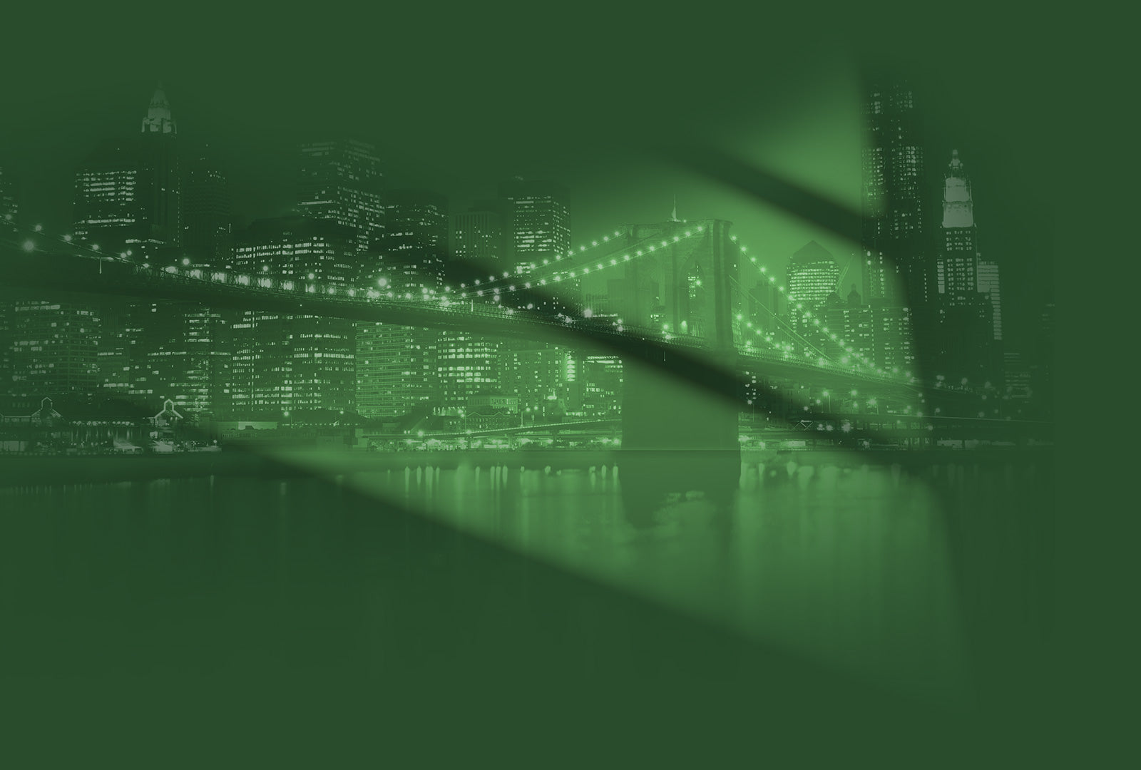 City skyline with illuminated buildings and a bridge at night, green filter