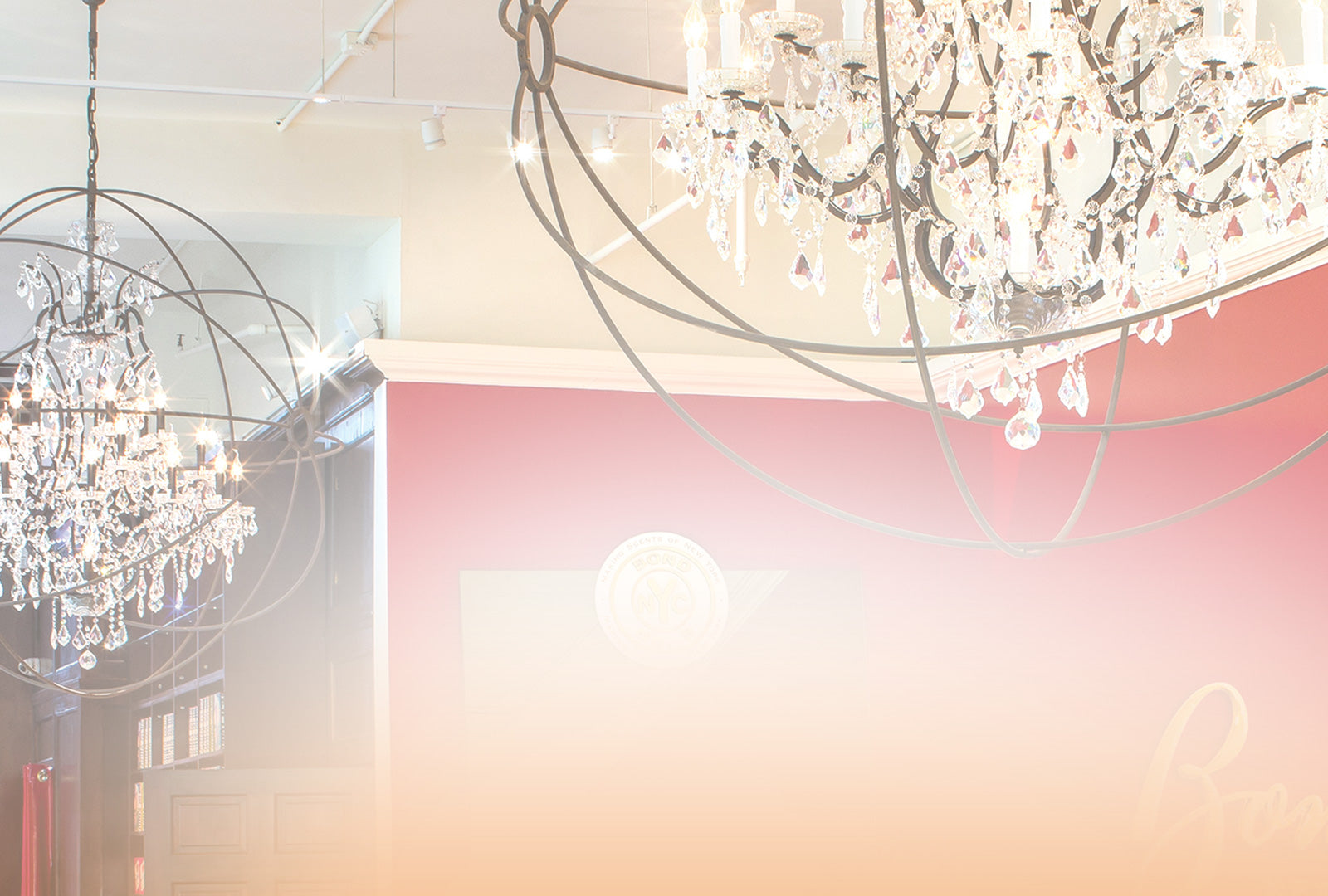 Two chandeliers hanging from a ceiling with a blurred background