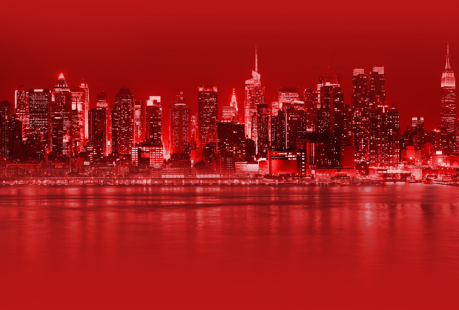 Red-tinted city skyline with reflections on water