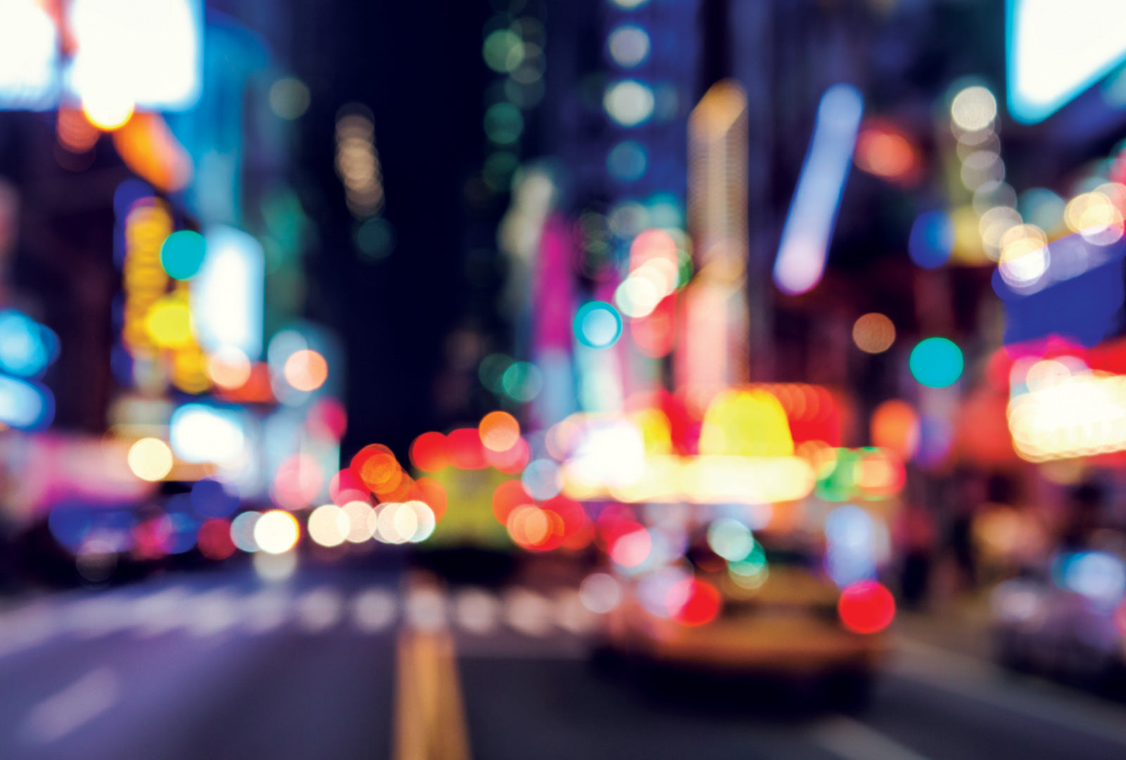 Blurred city street at night with colorful lights