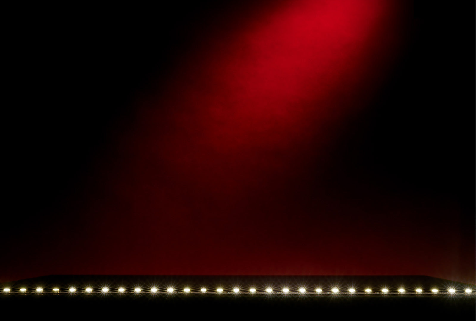 LED strip light emitting a warm glow against a dark background