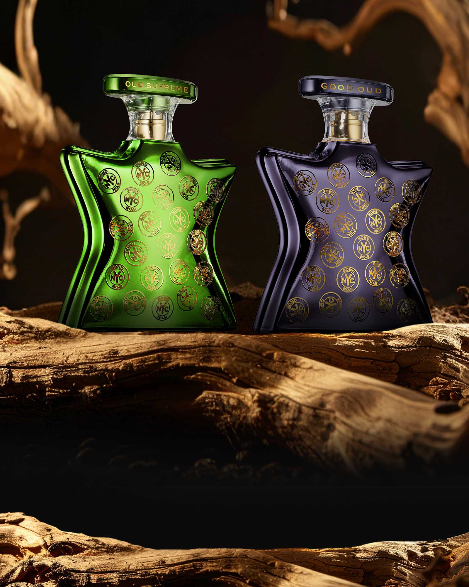 Two perfume bottles, one green and one blue, on a wooden surface with a dark background.