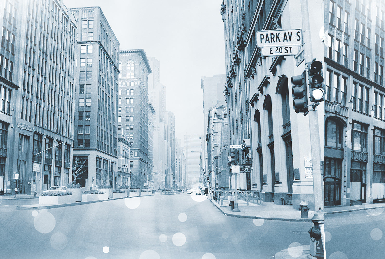 City street with tall buildings and traffic lights on a snowy day