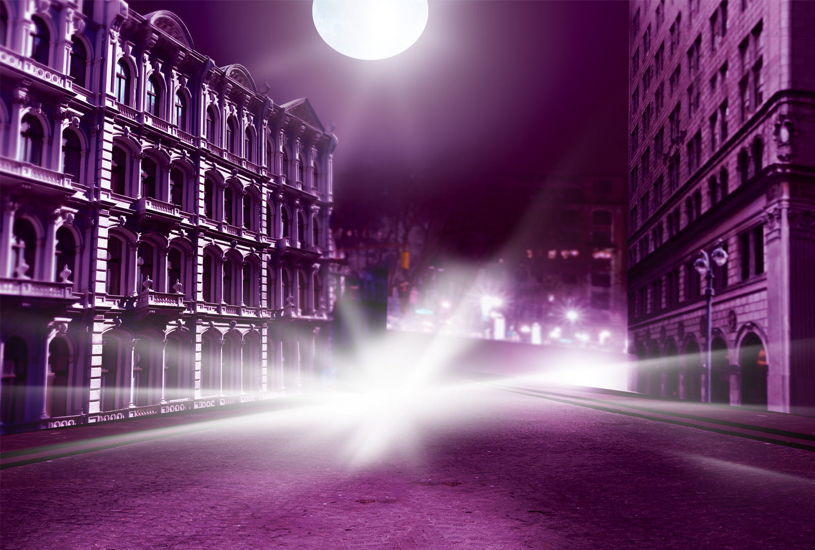 Purple-toned city street at night with illuminated buildings and streetlights.