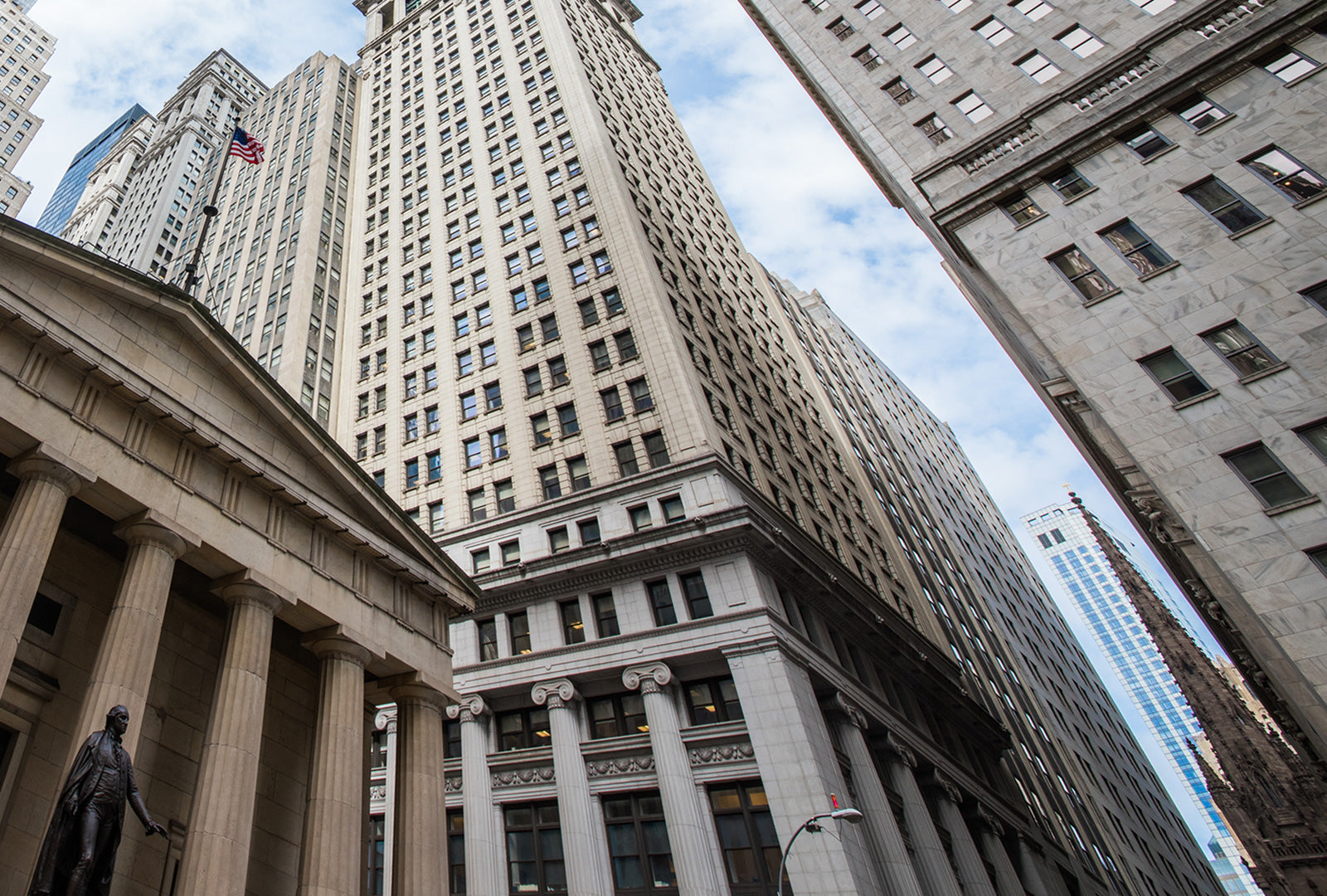 Tall buildings with classical architecture and a blue sky.