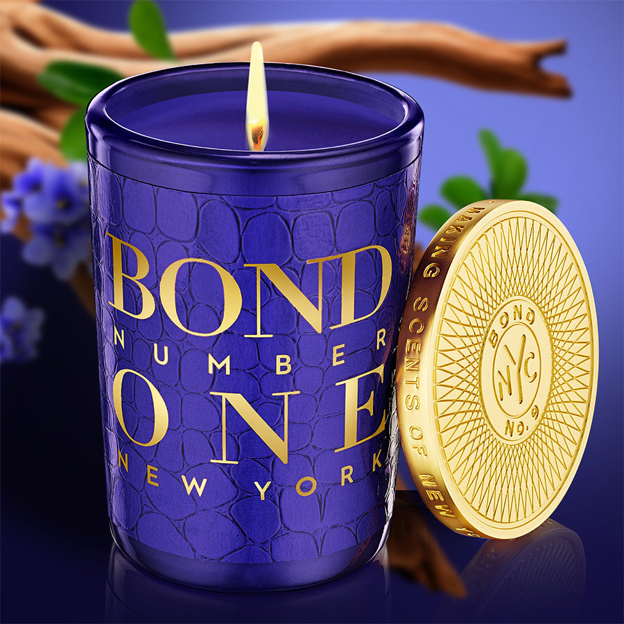 Blue candle with 'Bond Number One New York' branding and a gold coin on a blue background.