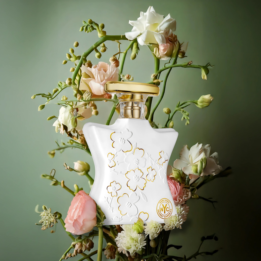 Perfume bottle with floral design on a green background